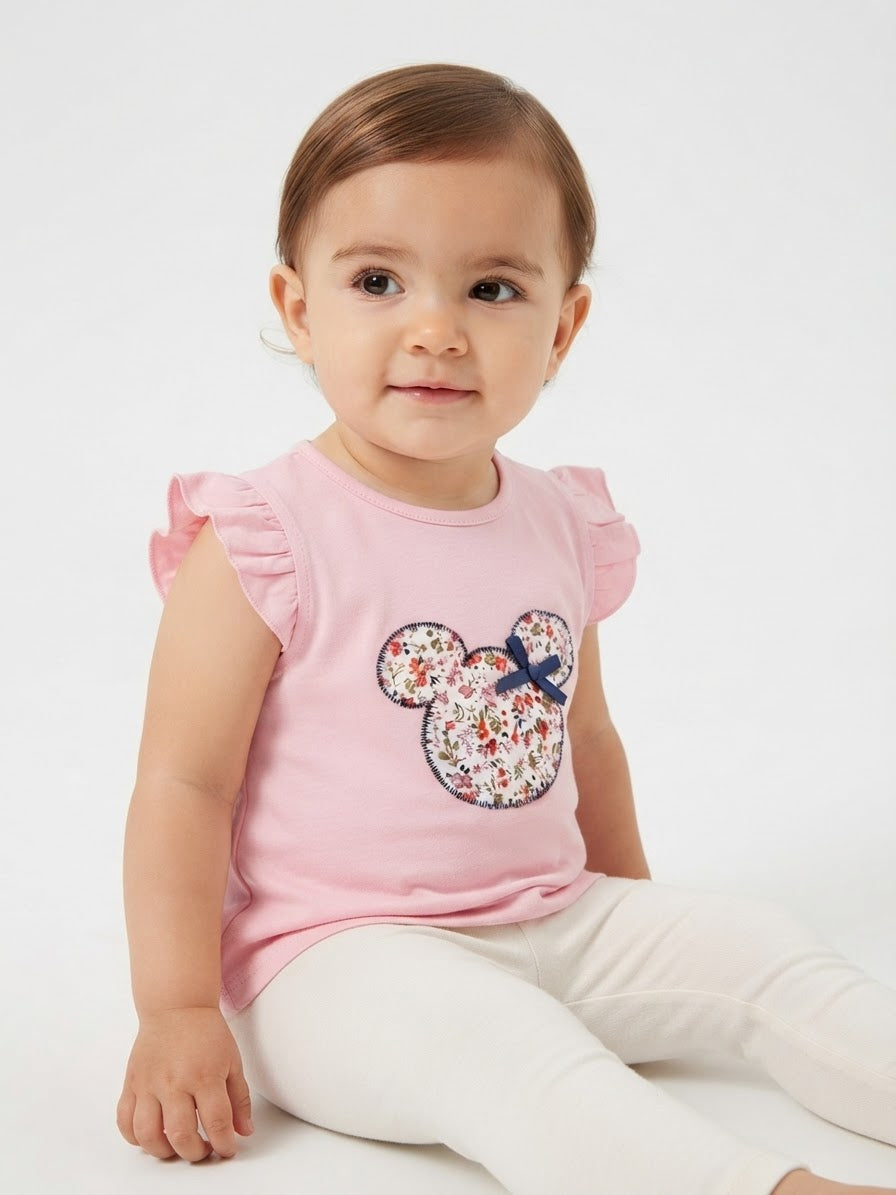 Blusa niña rosa con aplique floral y olanes